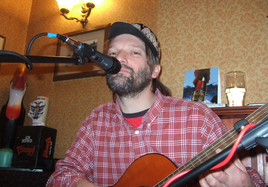 Alan Robinson playing guitar  at the Travellers Rest Draycott